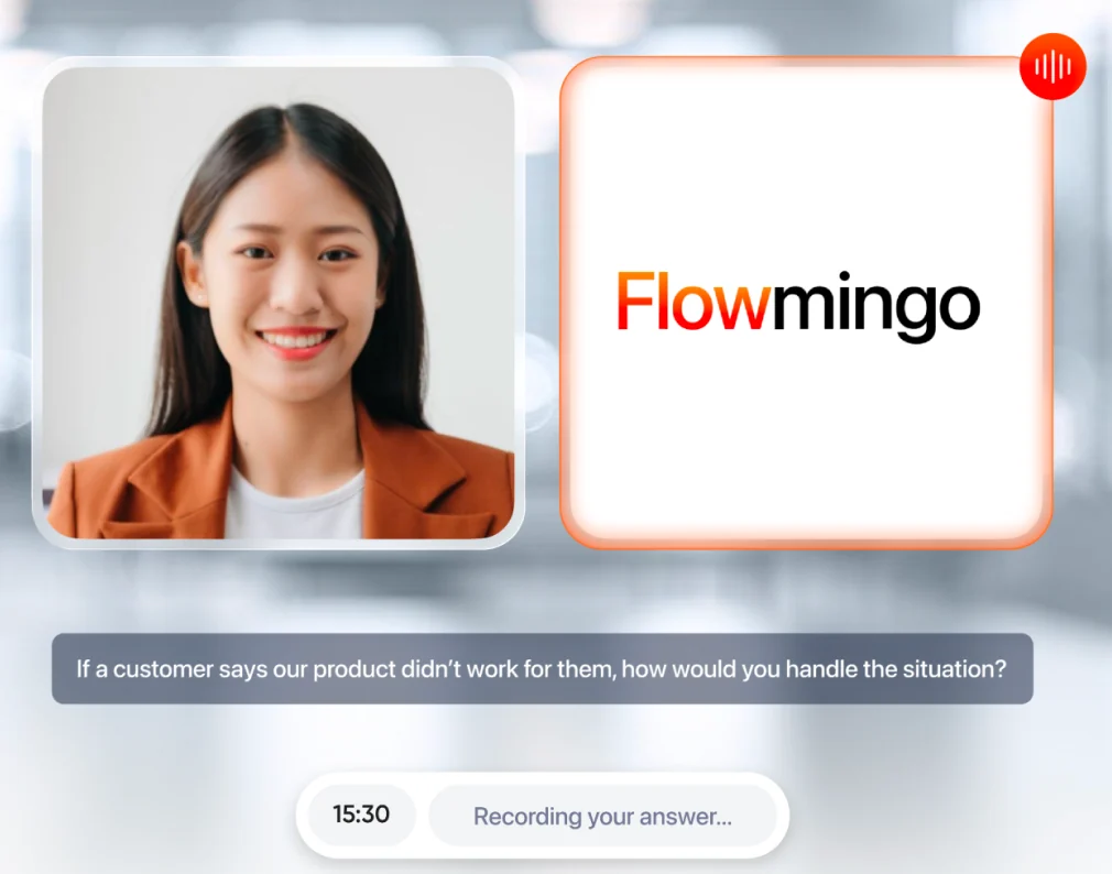 A Flowmingo AI interview in progress: the applicant on camera beside the Flowmingo AI tile, which is speaking, with the question on screen and the answer being recorded.